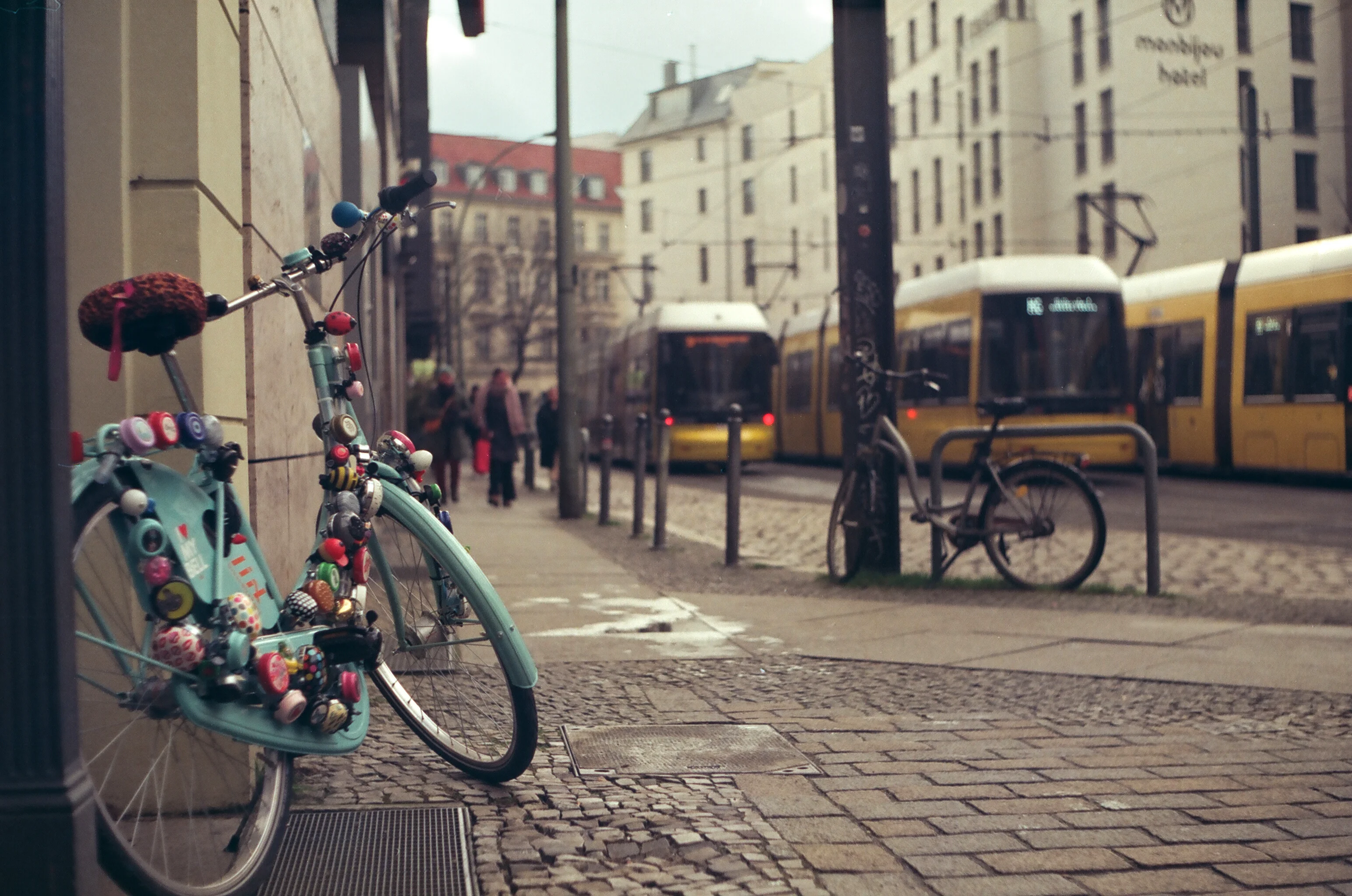 Colorful bike and trams in the background